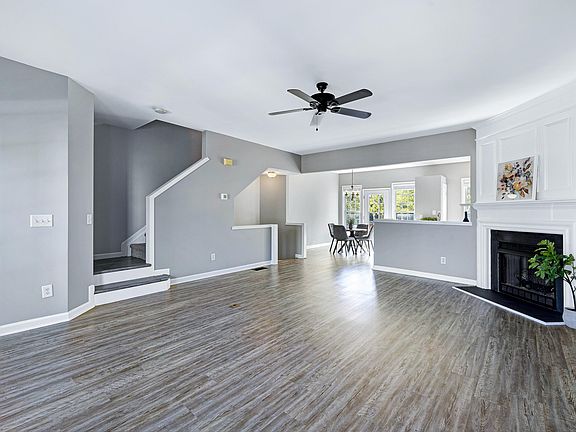 Large open area with fireplace and windows viewing the front and back