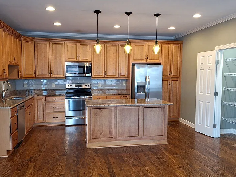 Penthouse Chef's kitchen complete with plentiful cabinets, pantry, and island