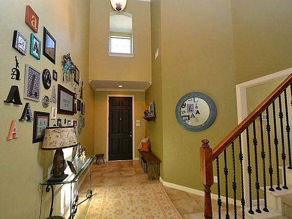 Elegant entry offering two story high ceilings, crown molding and tile flooring.