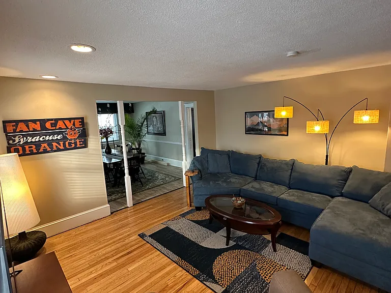 large living room with furniture, 50 inch smart tv, Alexa lighting and speakers