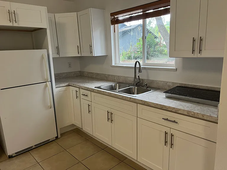 Another, closer view of the kitchen counters and cabinets.
