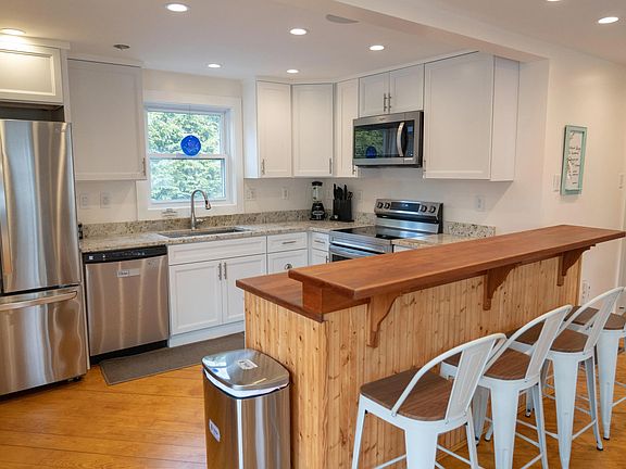 4 Bar stools overlook kitchen area