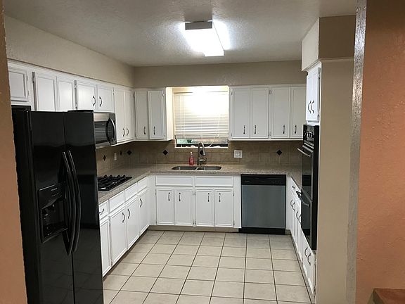 Large kitchen with new refrigerator, gas stove and dishwasher
