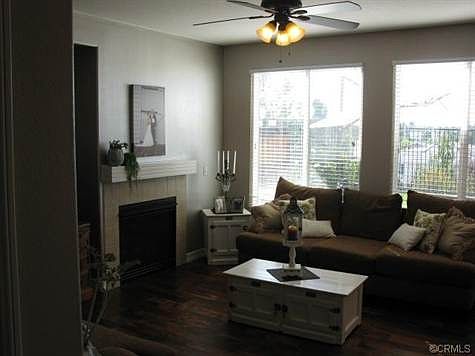 Living room w/ fireplace & custom ceiling fan.