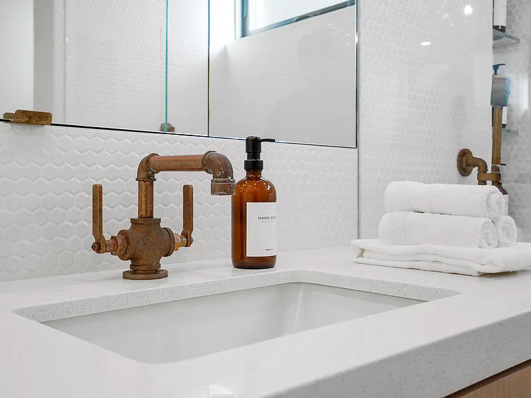Modern design, premium bath essentials, and warm brass accents.