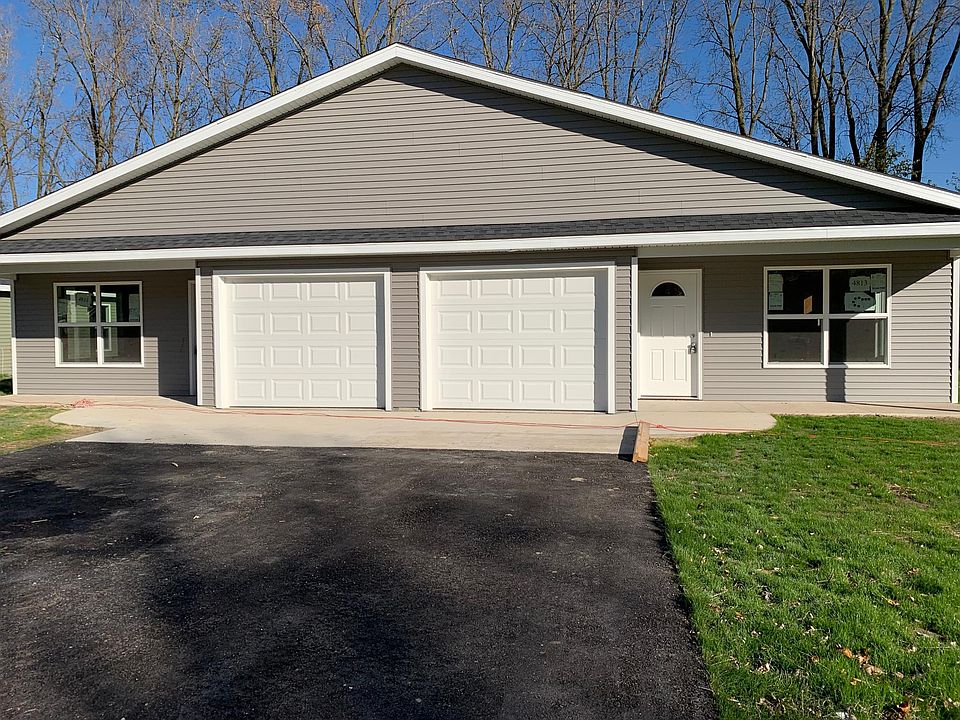 Front Exterior fully painted, beautiful grey vinyl siding with attached single car garage.