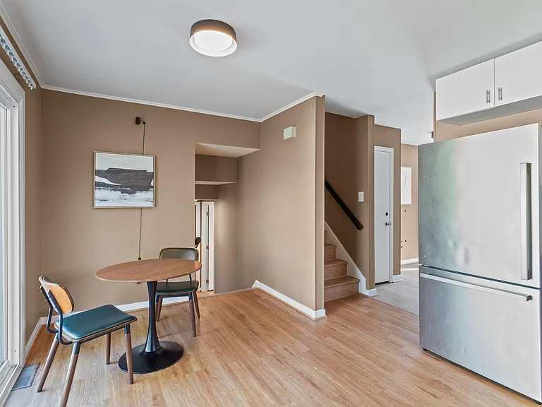 Open dining area beside the kitchen with a bistro table, ample natural light, and easy access to adjacent rooms.