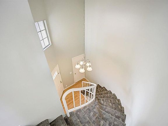 Main entry from main floor, front door (left), garage entrance (top center), stairs (bottom center).
