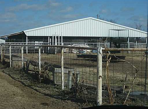 FRONT OF LIGHTED ARENA, HYDRANTS IN HOLDING PENS