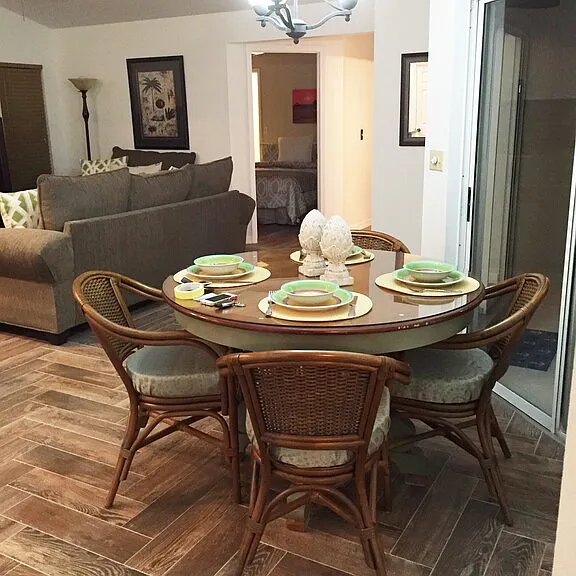 Kitchen nook area with sliders out to pool and view of outside and family room area.