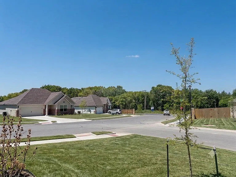Front porch view. Located near the edge of the neighborhood with fewer homes on the street _ a quiet, serene setting close to open country. And have easy access to main roads _ no winding through the community to get in and out.