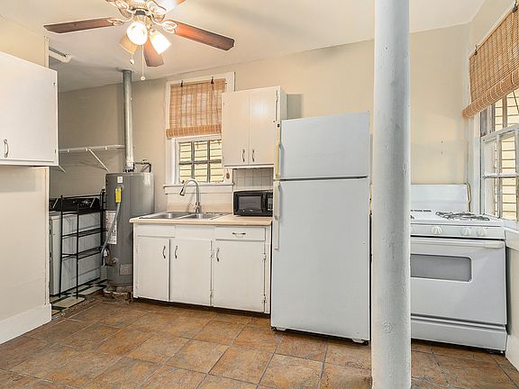 Kitchen with stove, refrigerator, and microwave (no dishwasher)
