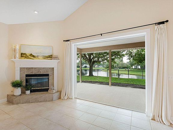 Woodburning fireplace & triple recessed glass doors to covered lanai