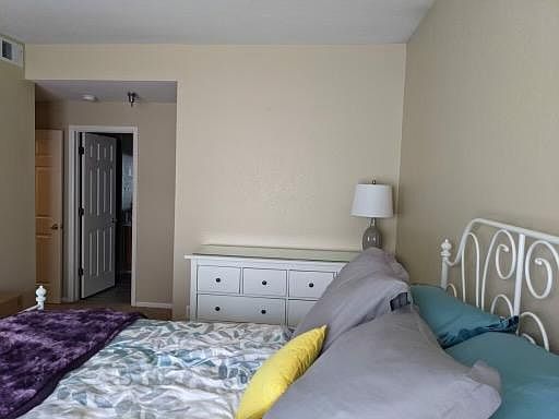 Master bedroom showing entrance to bathroom, with walk-in closet to right of bathroom.