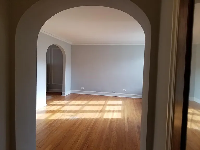 arched foyer with large walk in closet to theright and left
