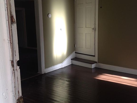 Living room with stairs to access upstairs bedrooms