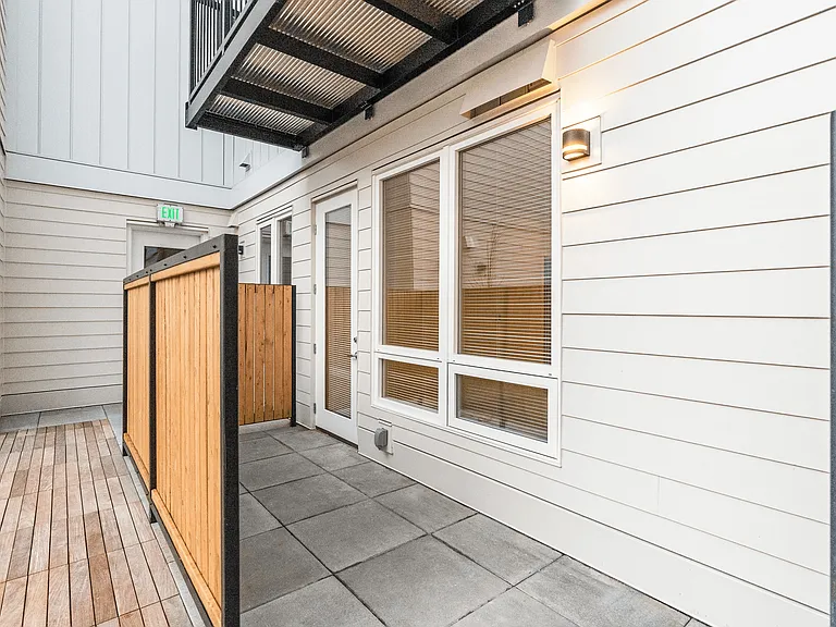 Private patio space with wood privacy panels and direct home access_perfect for fresh air and outdoor relaxation. Private patio space with wood privacy panels and direct home access_perfect for fresh air and outdoor relaxation.