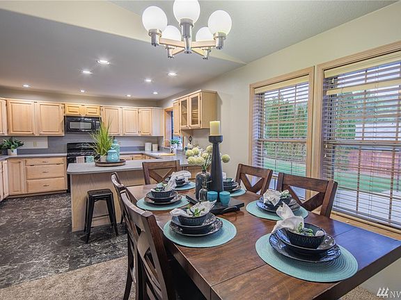 Super spacious living room area with vaulted ceilings and bay windows.