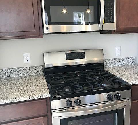 Gas stove and microwave, granite countertops