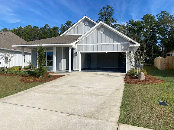 Front of house, large two car garage with epoxy flooring