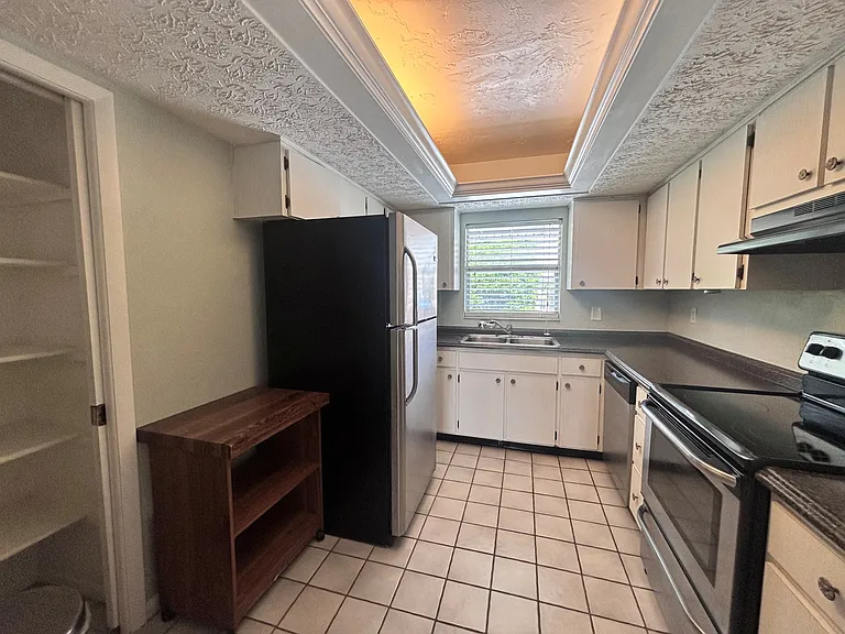 View of kitchen with better view of right side and appliances.