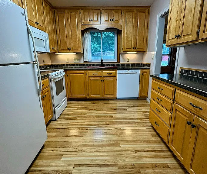Beautifully updated kitchen, Custom Maple Cabinetry. All kitchen appliances and upgraded HE Washer/Dryer included.