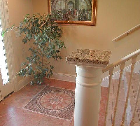 Tiled entry with wide staircase to main living area