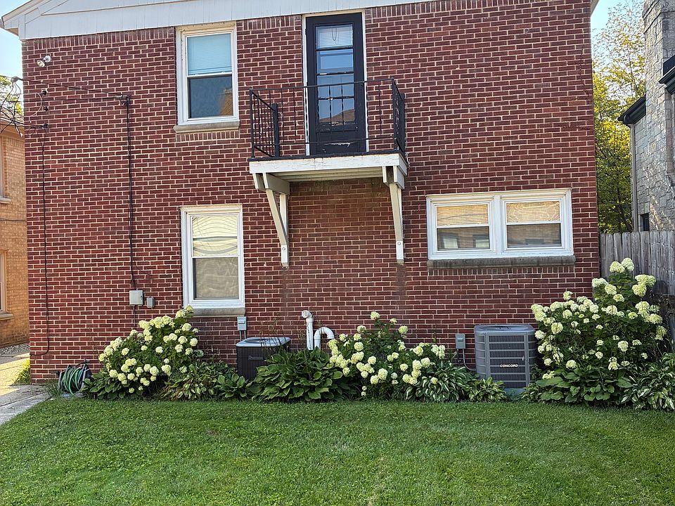 Back of building w/ balcony