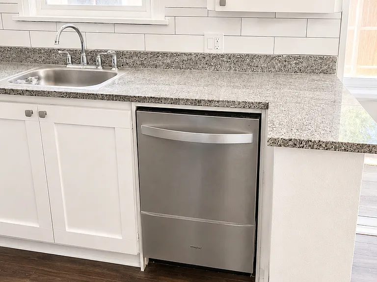 Brand-new stainless steel dishwasher with durable granite countertops.