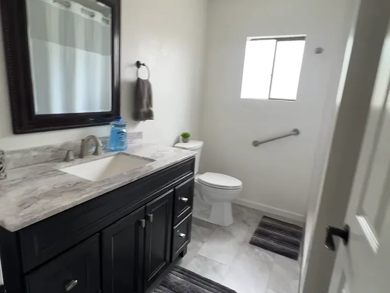 Bathroom in hallway has walk-in shower.