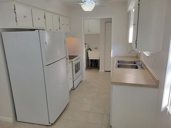 Kitchen looking from dining area toward laundry room