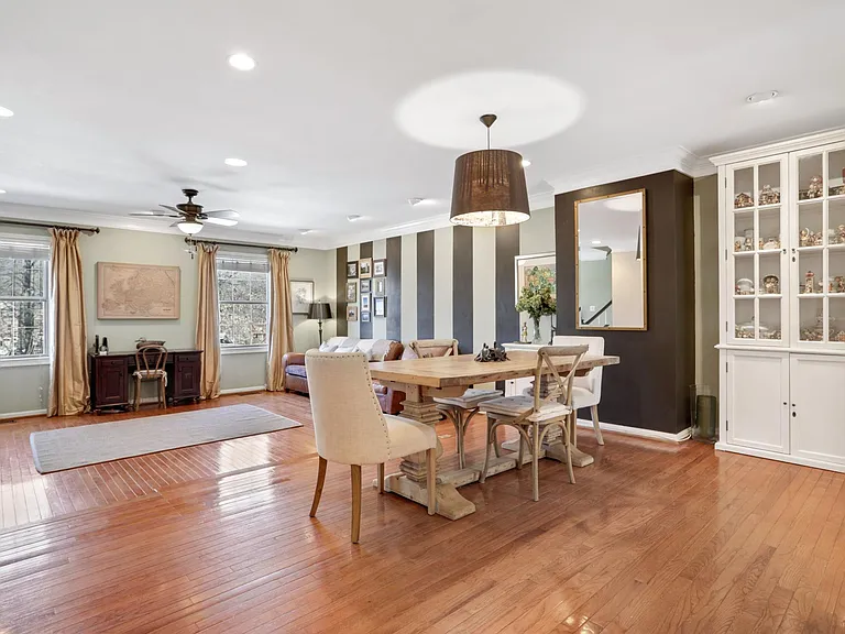 Remodeled second floor with recessed lights, hardwood floor and wooded view.