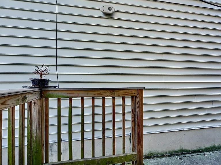 Backdoor leads to small deck and alleyway