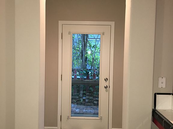 Mudroom with pantry shelves off of kitchen.