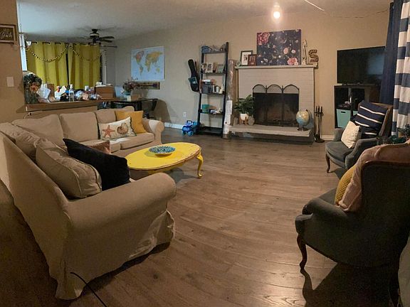 Front main room, with wood fire place. Funny room back right and kitchen to the left of that.