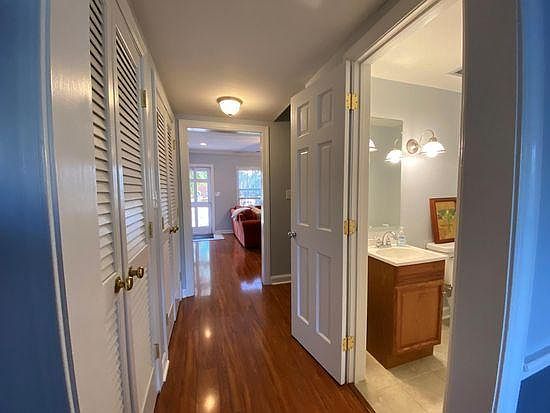 Hallway from entrance/Livimg room with half bath in hallway leading to kitchen/dining