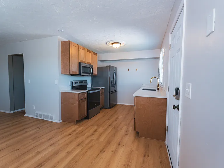 Newly designed kitchen with new cabinets, countertops, sink, hardware, and flooring