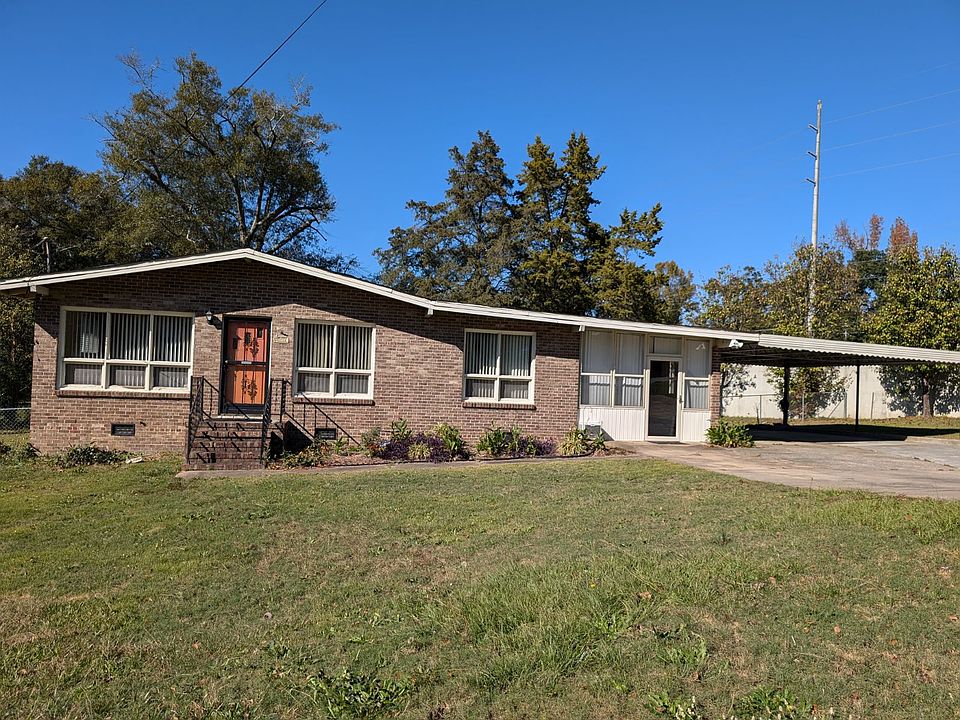 Enclosed carport, with two additional covered parking spaces.