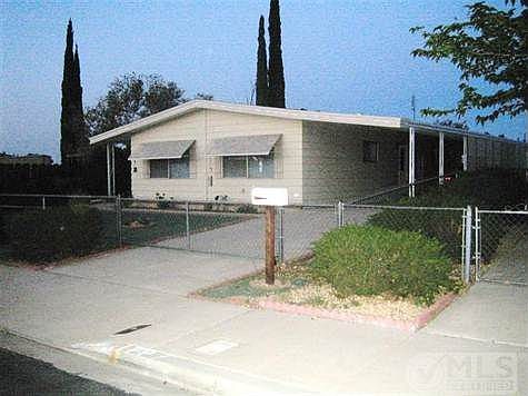 Front view of property. Driveway area on both  sides for ample parking for cars, toys, barbeque, etc.