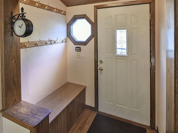 into a foyer with with bench