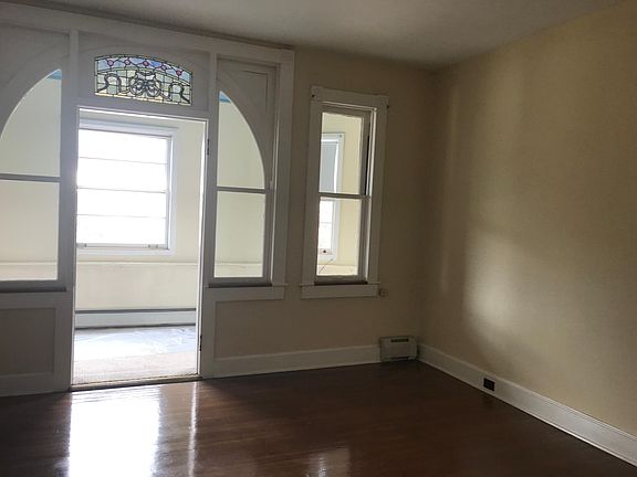 Spacious bedroom / living room with adjoining sun porch. Lovely hardwood floors.