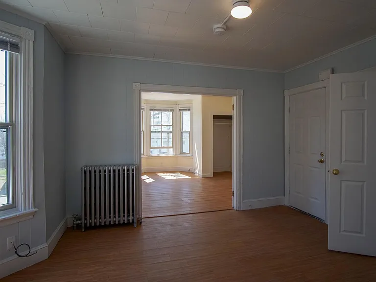 View from kitchen doorway, through either dining room or living room. Room through the french doors is either master bedroom or sunny living room.