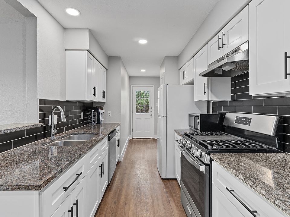 Kitchen with laundry hookups in the back.