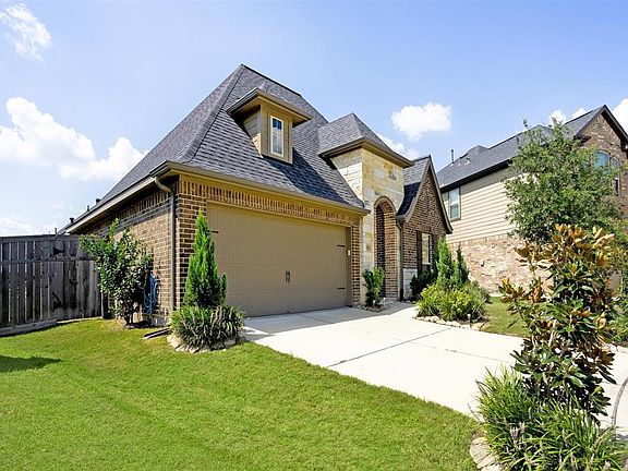 Double driveway leading to 2-car garage