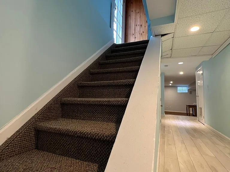Private staircase down to apartment.