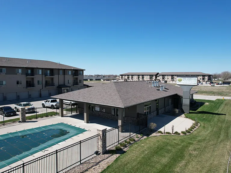 Back of the clubhouse with the pool at The Sterling at Grand Island.