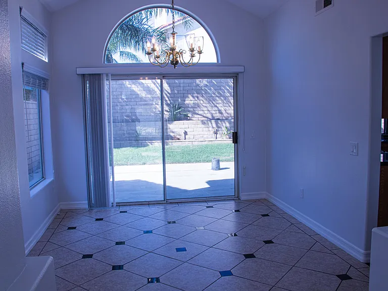 Formal dinning room connected to the kitchen and family room with sliding doors that lead into the backyard