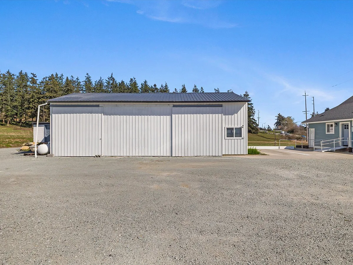 The NW corner slider door is for landlord storage. SW corner slider is fixed in place, walled up inside the building. Parking pad is for the other occupant living in the blue house to the south. - State Route 532