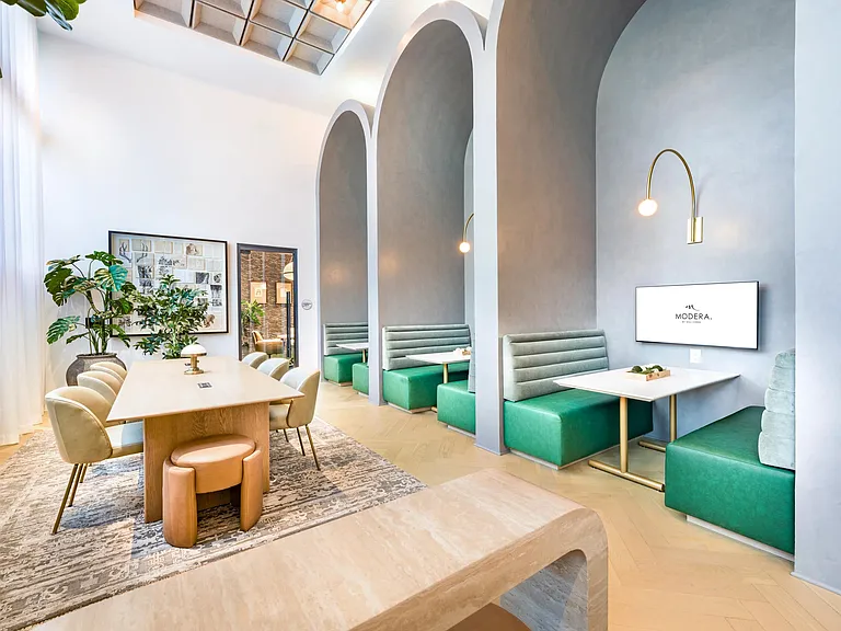 Community cowork and dining lounge with arched alcoves and shared tables, offering a refined place to gather near Nashville's Music City energy and creative scene.