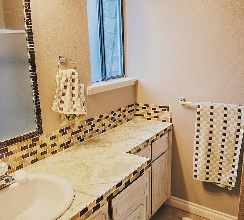 Custom glass tiled backsplash with retro countertop